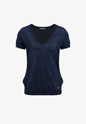Haut court en maille bleu marine à manches courtes et col en V, avec ourlet et poignets côtelés, arborant un petit logo métallique rond près de la taille.