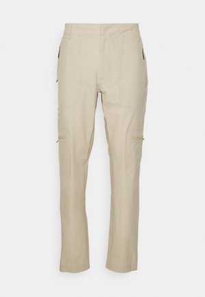 Beige cargo bukser med lige snit, der har lynlåslommer i siderne og diskrete stikninger. Fremstillet af letvægts og holdbart stof.