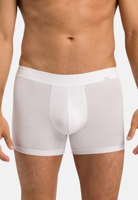 White cotton boxer briefs with a soft, stretchy waistband, form-fitting design, and seamless construction for comfort. No visible patterns.