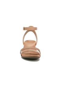 Nude leather sandal with a flat sole, featuring two braided straps and an ankle strap with a metal buckle. Smooth texture throughout.