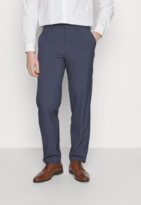 Blue tailored trousers with a smooth texture, featuring a flat front and side pockets, paired with brown leather dress shoes.