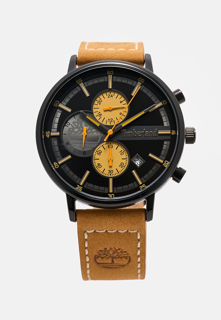 Zwarte chronograaf horloge met gele accenten, een ronde wijzerplaat, drie molens, en een tan lederen band met stiksels en logo-detail.