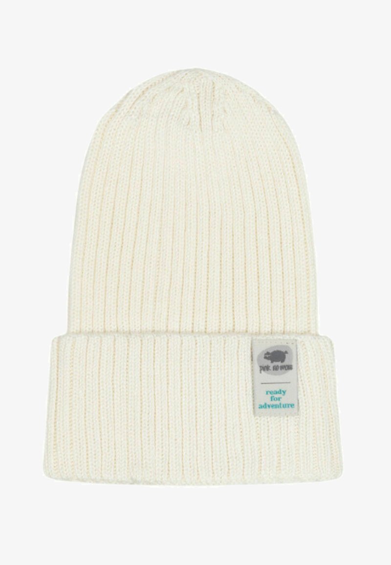 Knitted cream beanie with ribbed texture and fold-over cuff. Features a small label with a logo and the text "ready for adventure."
