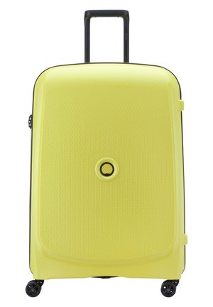 Hard-shell suitcase in bright yellow with a textured surface, black handle, and four black wheels for mobility. Circular logo on front.
