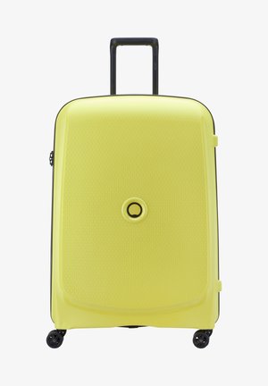 Hard-shell suitcase in bright yellow with a textured surface, black handle, and four black wheels for mobility. Circular logo on front.