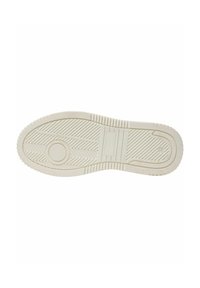 Semelle de chaussure en caoutchouc de couleur claire avec un motif texturé, dotée de rainures et d'un accent circulaire. Design plat avec une légère courbure aux bords.