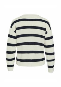 Pull en maille avec un motif rayé en crème et marine. Il comporte un col rond, des manches longues et des poignets côtelés.