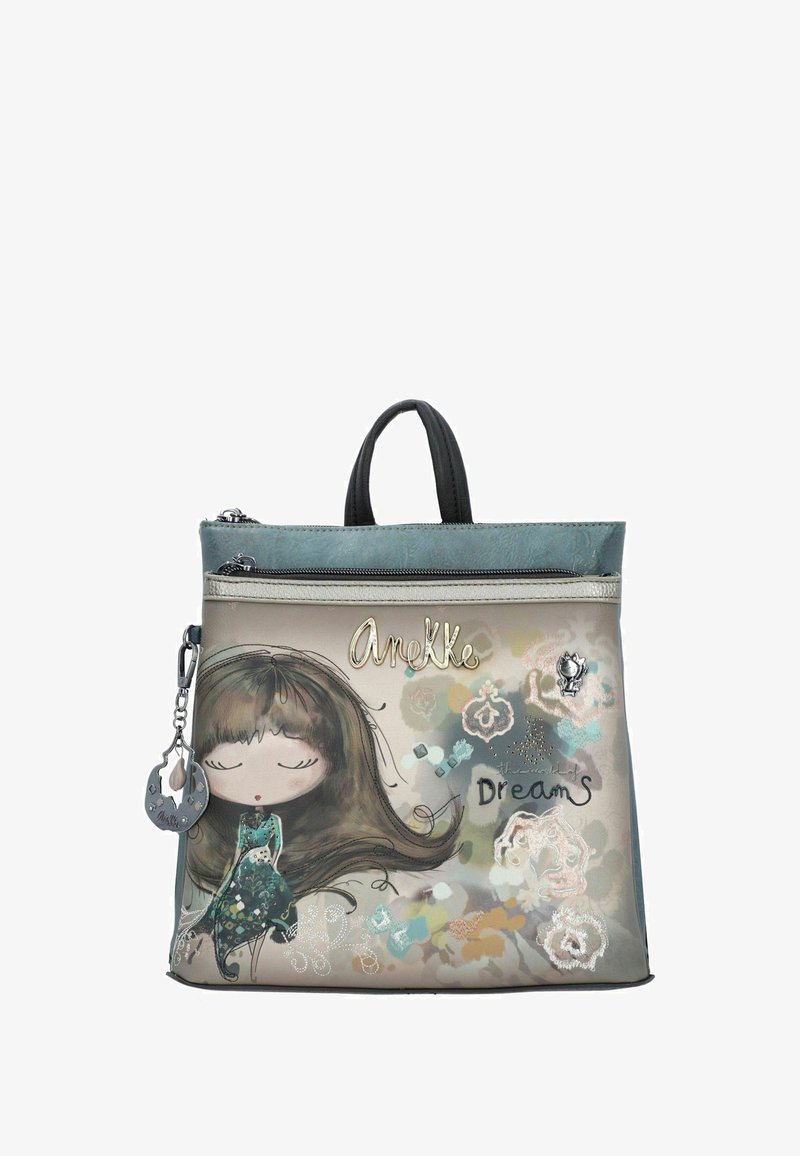 Bolsa verde y beige con una ilustración de una niña de dibujos animados, cierre de cremallera y asas negras, con acentos decorativos y el texto "Sueños Desplegados".