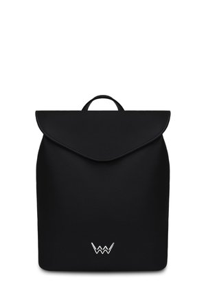 Black faux leather backpack with a flap closure, rounded edges, and a prominent silver logo at the bottom. Features a top handle for carrying.