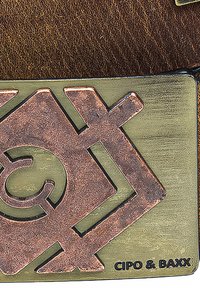 Metal badge with geometric design featuring a copper finish, engraved details, and the text "CIPO & BAXX" on a green background.