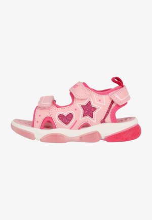 Sandalia rosa con parte superior sintética brillante con diseños de corazones y estrellas con purpurina, tiras ajustables y suela de goma acolchada.