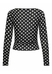 Top nero a maniche lunghe con pois bianchi. Presenta un orlo dritto e un colletto rotondo con una leggera elasticità nel tessuto.