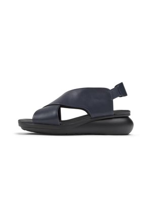 Navy blue open-toe sandal with crisscross leather straps, padded sole, and elastic slingback on a thick black cushioned platform.