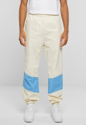 CORPORATE BLOCK - Tracksuit bottoms - creme light blue