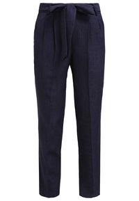 Námořnické modré lněné kalhoty s širokým pasem a zavazovacími pásky. Obsahují sklady a zúžené nohavice pro strukturovaný vzhled.