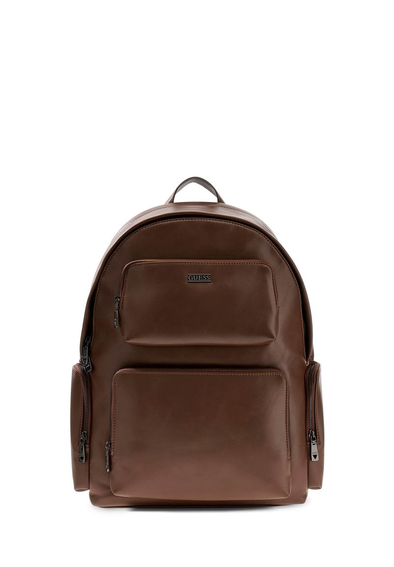 Sac à dos en cuir marron avec une forme arrondie. Il dispose d'une poignée supérieure, de plusieurs poches zippées et d'une texture lisse avec un branding subtil.