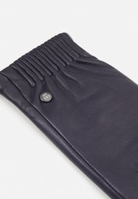 Navy leather glove with gathered wrist detail, featuring a small black button accent and smooth texture. Concise design, no visible patterns.