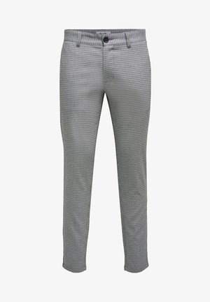 Pantalon chevrons noir et blanc en tissu tissé. Avec une fermeture à bouton et des passants de ceinture. Coupe slim avec jambes droites.