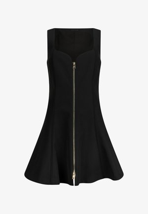 Melnā bezsleja kleita ar pieguļošu augšdaļu un izplestu svārku. Aprīkota ar priekšējo rāvējslēdzēju un gludu, austas auduma tekstūru.