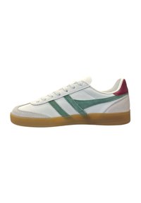 White sneaker with green suede stripes, pink heel accent, rubber gum sole, and textured body. Laced design and rounded toe.