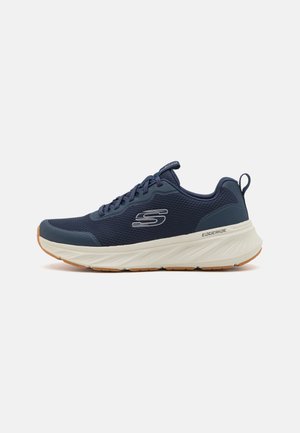 Navy mesh athletic shoe with white cushioning sole and rubber outsole; features lace-up design and side logo detail.