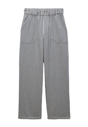 Pantalon ample à rayures verticales noires et blanches, avec taille élastique et poches latérales.