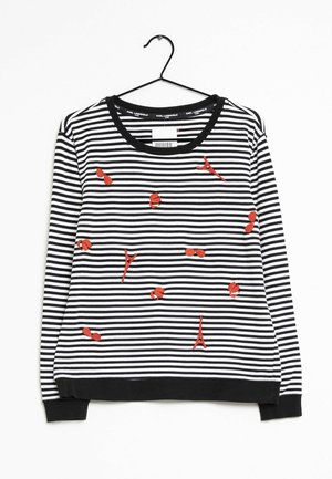 Sweatshirt rayé noir et blanc avec des accents brodés rouges, y compris des motifs stylisés. Col rond et poignets côtelés.