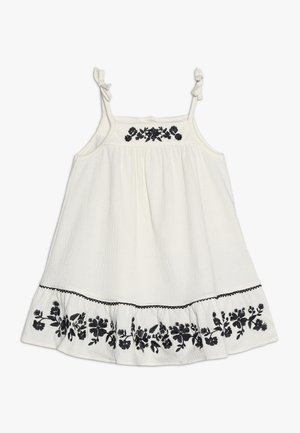 Hvid ærmeløs kjole med tynde bindebånd, sort blomsterbroderi på bryst og kant samt tekstureret stof.