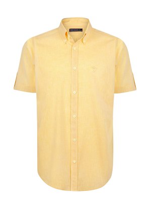 Camisa de manga corta con botones en una suave tela amarilla, que presenta una textura sutil y un pequeño logo bordado en el pecho.