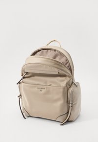 Zaino in nylon beige con una texture liscia, compartimenti doppi con zip, tasca frontale e dettagli in metallo argentato.
