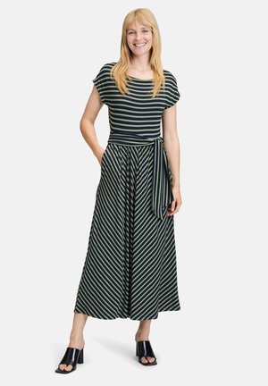 Striped maxi dress in navy and olive, featuring short sleeves, a cinched waist with a tied belt, flowing fabric, and black heeled sandals.