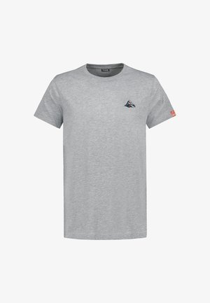 Plain light grey short-sleeve T-shirt with a small mountain graphic on the left chest and a small orange logo patch on the right sleeve.