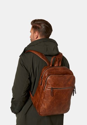 Brown leather backpack with multiple zippered pockets, a rectangular shape, smooth texture, and adjustable shoulder straps.