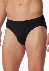 Schwarze Herrenunterwäsche aus weichem Stoff mit glatter Textur, elastischem Bund und einem klassischen Schnitt für gute Abdeckung und Unterstützung.