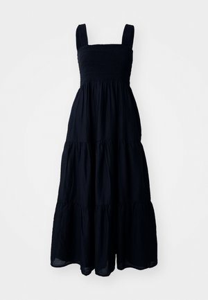 Schwarzes Maxikleid mit quadratischem Ausschnitt, breiten Trägern und gestuften Rüschendesign, das einen gerafften Oberteil für zusätzliche Textur bietet.