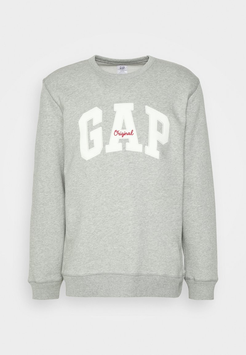 Sweat-shirt gris clair à col ras du cou avec "GAP" en grandes lettres blanches et "Original" en petite écriture rouge centrée sur la poitrine.