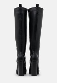 Black knee-high boots made of smooth leather, featuring a block heel, rear zipper closure, and pull-tabs at the top for easy wear.