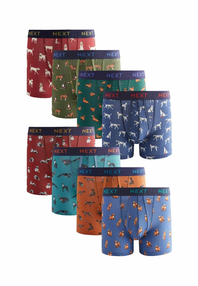 Neun Paar Boxershorts mit verschiedenen Hundemustern in den Farben rot, grün, blau und orange. Elastischer Bund mit dem Aufdruck "NEXT."
