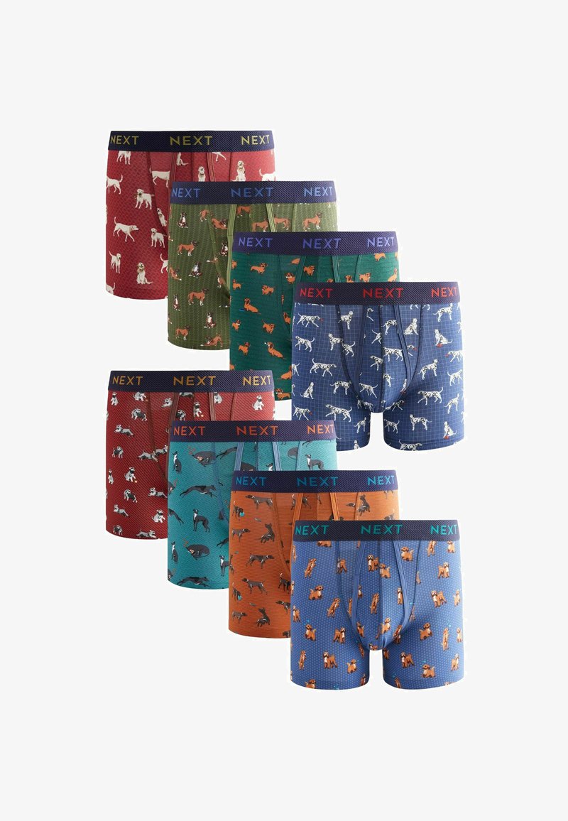 Nine pairs of boxers featuring various dog patterns, with colors including red, green, blue, and orange. Elastic waistband labeled "NEXT."