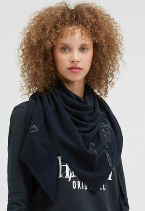Dark navy triangular scarf made of soft fabric, featuring a smooth texture and subtle silver accents. Draped around the shoulders.