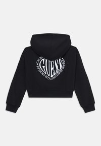 Black cropped hoodie with a drawstring hood. Features a large white graphic logo on the back, text includes "Guess" and "Established 1981."