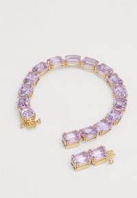 Gold-toned bracelet featuring rectangular light purple stones, set in claw-like prongs, with a clasp detail and smooth polished finish.