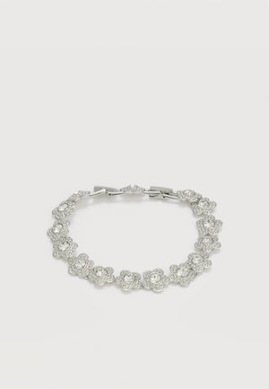 Sudraba aproce ar zieda formas saitēm, katra stiprināta ar caurspīdīgiem apaļiem kristāliem, uz vienkārša baltā fona.