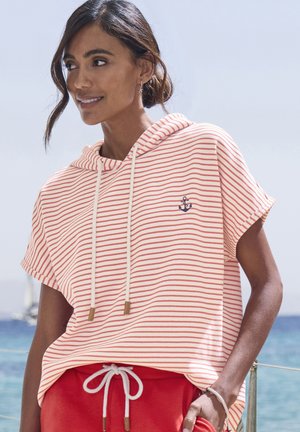 Striped short-sleeve hoodie in coral and white with a drawstring and anchor logo. Paired with red shorts, displaying a relaxed fit.