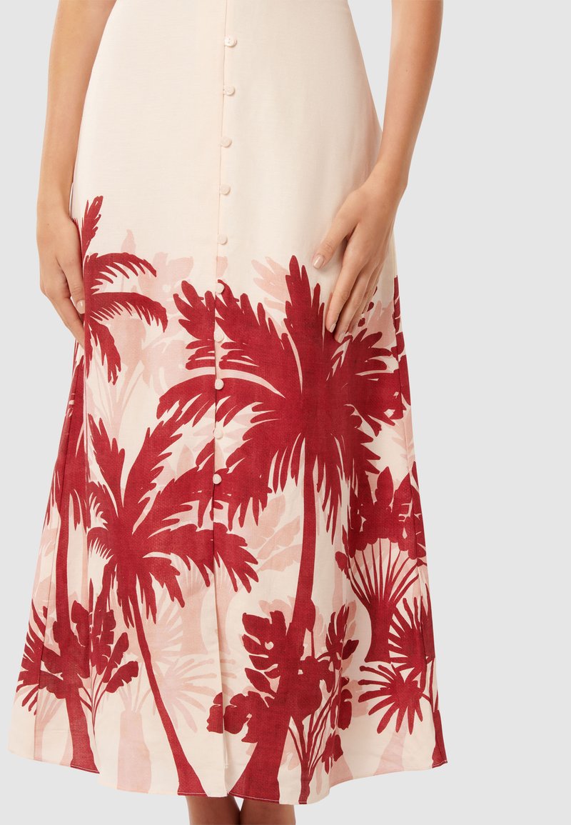 Licht beige rok met een rode palmbomenprint, met een knoopsluiting aan de voorkant, een licht uitlopende vorm en een zachte, gestructureerde stof.
