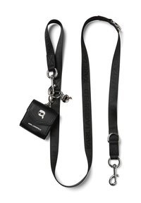 Black leather mini bag with a silver logo and skull detail, attached to a black strap with "KARL LAGERFELD" branding and metal accents.