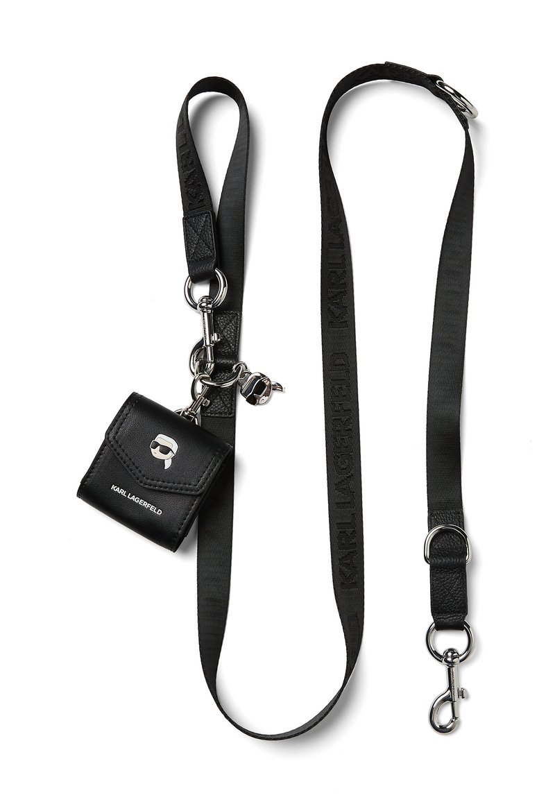 Black leather mini bag with a silver logo and skull detail, attached to a black strap with "KARL LAGERFELD" branding and metal accents.