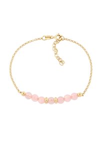 Bracelet chaîne en or avec cinq perles rose clair séparées par des intercalaires en or, présentant un design délicat et une texture lisse. Fermoir mousqueton sécurisé.