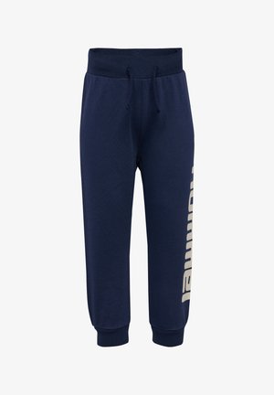Marineblauwe sweatpants van een katoenmix, met een tailleband met trekkoord en een groot beige logo dat langs het linkerbeen is bedrukt.