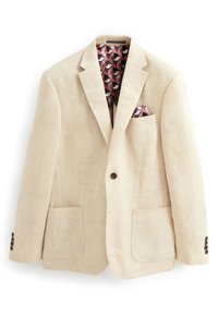 Blazer en lin beige avec revers cranté, deux poches avant et une doublure intérieure à motifs comportant des designs circulaires roses et gris.